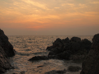 Sunset view over sea with stones