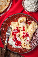 Rolled crepes stuffed with cottage cheese.