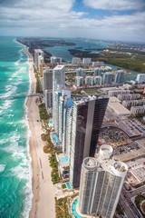 North Miami Beach as seen from helicopter. Skyscrapers along the ocean, aerial view - obrazy, fototapety, plakaty