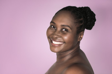 Smiling African woman with beautiful skin against a lavender background
