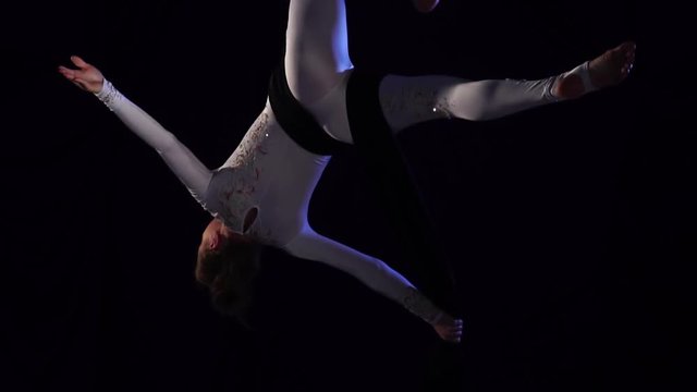 woman dancer on aerial silk, aerial contortion, aerial ribbons. Slow Motion