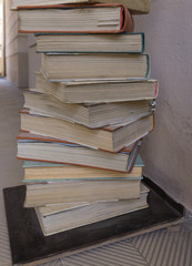 Many old books stacked on top of each other