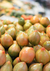 Heap of fresh tomatoes. Organic produce in a market.