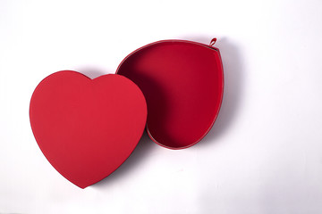 Open empty red gift box with a heart shape isolated on white background.