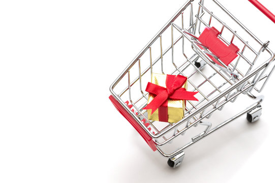 Gift box and shopping cart on white background : economy concept