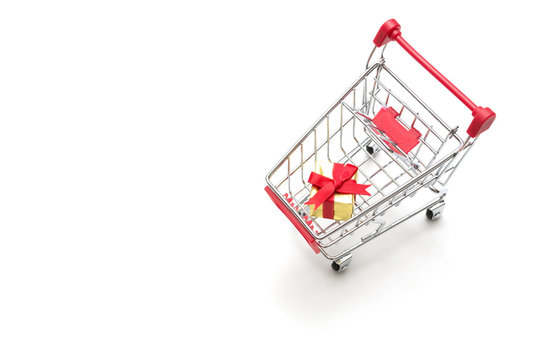 Gift box and shopping cart on white background : economy concept