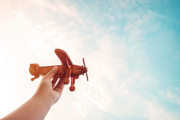 Childhood inspiration - Hands of children holding a toy plane and have dreams wants to be a pilot -...