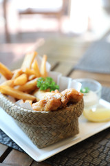 Fish and chips in close up on wood table background