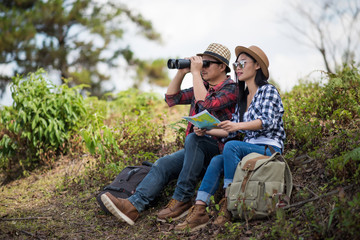 young couple relaxing sitting in forest