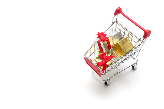 Gift box and shopping cart on white background : economy concept