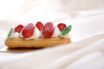 Choux cream with strawberry isolated in white background