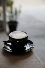 Cappuccino coffee cup on wood background