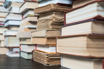 Many books in a bookstore or library on wooden background with copy space
