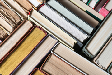 Many books in a bookstore or library on wooden background with copy space