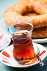 Turkish food: simit bread and cup of tea, shallow DOF