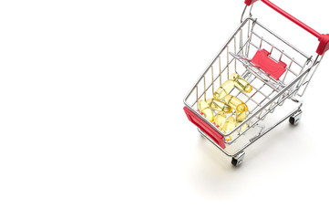 Pills and shopping cart on white background : economy concept