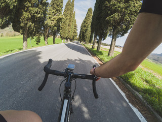 Personal perspective of a cyclist training in Tuscany on a racing bicycle on a spring day