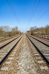Fototapeta na wymiar Spring landscape with railway under blue sky