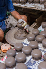 Close up of female hands working on potters wheel