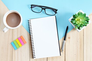 Still life, business, office supplies, planning or education concept : Top view or flat lay of open notebook with blank pages and coffee cup on office table, ready for adding or mock up