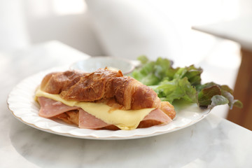 Sandwich ham and cheese on white table in coffee shop