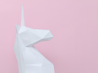 White paper unicorn on a pink background. Space for text © somemeans