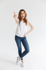 Full length image of Happy woman in t-shirt posing