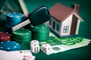 Poker chips with car keys and house