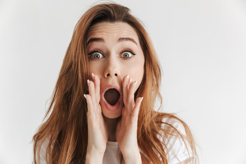 Surprised woman in casual clothes screaming with arms near mouth