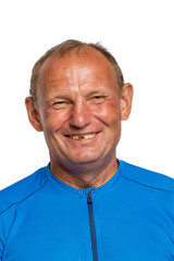 An elderly balding tanned man laughs