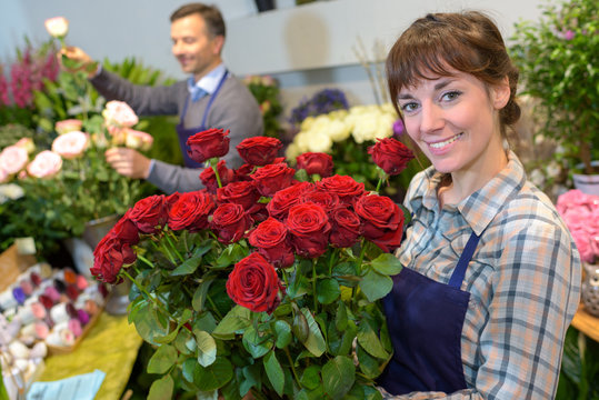 female florist holding bouquet of roses