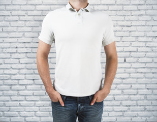 Man wearing blank shirt on brick background