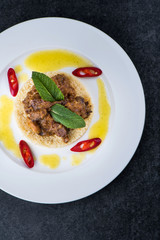 Delicious cooked couscous with meat on a white plate