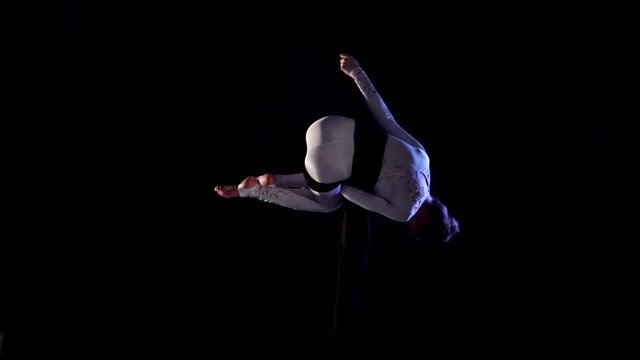 woman dancer on aerial silk, aerial contortion, aerial ribbons. Slow Motion