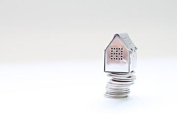 Business, finance, saving money, property ladder or mortgage loan concept : House model standing on coins stack