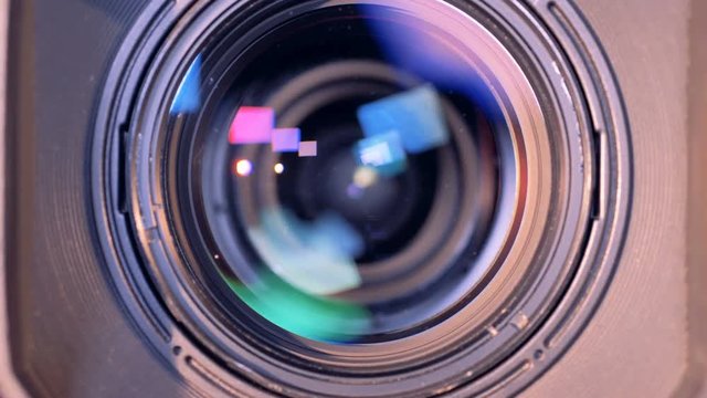 Camera lens is turning towards the viewer and is zooming out