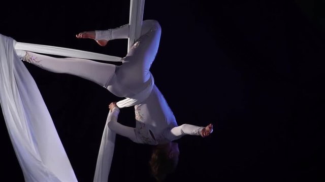 woman dancer on aerial silk, aerial contortion, aerial ribbons. Slow Motion