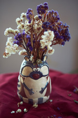 The vase with flowers stands on the table