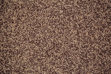 Seamless tileable texture of decorative wall surface covered with small brown and white stones