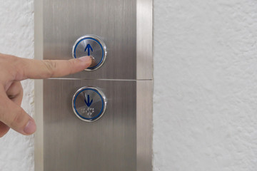 Using hands, press the elevator up and keypad elevator