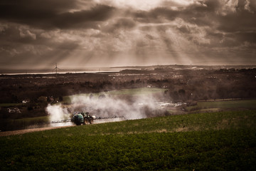 Farmer fertilizing arable land with nitrogen, phosphorus, potassium fertilizer