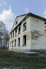 Fototapeta na wymiar Fragment of building after military operations in Donetsk