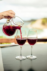 She pours the Sangria into two glasses 