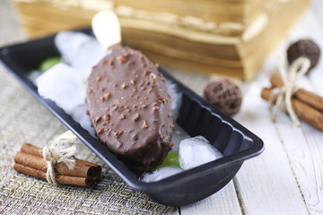 Dessert chocolate ice cream with nuts on wooden stick