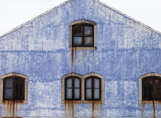 Frontal view of Rusted windows and grunge galvanized house.