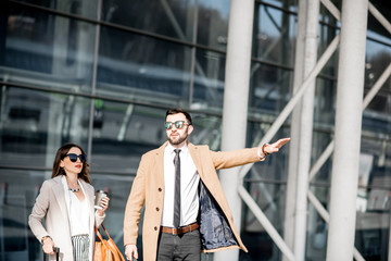 Business couple catching a taxi