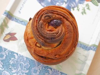 Modern dessert. Cruffin pastry upon colorful napkin. Close up, top view. Selective focus.