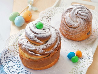 Traditional Russian easter cake. Cruffin dessert, decorated with sugar powder and easter eggs. Homemade treat. Selective focus.