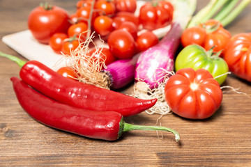 Closeup of various types of vegetables from Italy such as tomatoes, fresh Tropea onion (Calabria) and Sicilian spicy chili.