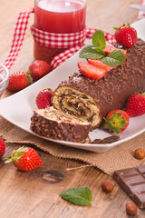 Chocolate roll with strawberries. 